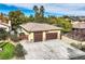 Two-car attached garage with light brown doors at 5895 S Gateway Rd, Las Vegas, NV 89120