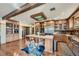 Modern kitchen with stained wood cabinetry, stainless steel appliances, and a large island at 5895 S Gateway Rd, Las Vegas, NV 89120