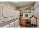 Bright laundry room, features washer, dryer, and built-in cabinets at 5895 S Gateway Rd, Las Vegas, NV 89120