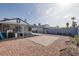 Large backyard with covered patio, brick pavers, and gravel at 59 N Christy Ln, Las Vegas, NV 89110