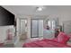 Bedroom with pink bedding and access to patio at 59 N Christy Ln, Las Vegas, NV 89110