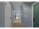 Light gray hallway with wood-look floors and doors to rooms at 59 N Christy Ln, Las Vegas, NV 89110