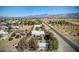 Aerial view showcasing a house's setting, nearby road, and expansive desert landscape at 5981 Doubletree Rd, Pahrump, NV 89061