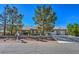 Single-story house with a two-car garage and landscaped yard at 5981 Doubletree Rd, Pahrump, NV 89061