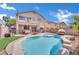 Inviting backyard oasis featuring a sparkling pool, patio, and fire pit at 6145 Sydney Bay Ct, North Las Vegas, NV 89081