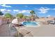 Relaxing kidney-shaped pool with patio furniture in a sunny backyard at 6145 Sydney Bay Ct, North Las Vegas, NV 89081