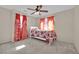 Bedroom with ceiling fan and red curtains at 6145 Sydney Bay Ct, North Las Vegas, NV 89081