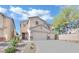 Two-story house with attached garage and landscaping at 6145 Sydney Bay Ct, North Las Vegas, NV 89081