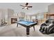 Game room boasts a pool table, fireplace, and kitchen views at 6145 Sydney Bay Ct, North Las Vegas, NV 89081