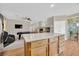 Kitchen features an island and wood cabinets at 6145 Sydney Bay Ct, North Las Vegas, NV 89081