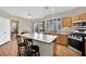 Kitchen with island, stainless steel appliances, and wood cabinets at 6145 Sydney Bay Ct, North Las Vegas, NV 89081