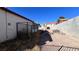 Backyard with chain link fence, satellite dish, and a dirt area at 6166 Evensail Dr, Las Vegas, NV 89156