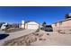 House exterior showcasing a driveway and a spacious front yard at 6166 Evensail Dr, Las Vegas, NV 89156