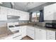 Bright kitchen features granite countertops and white cabinetry at 6223 Foothill Blvd, Las Vegas, NV 89118