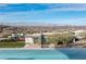 In-ground pool with panoramic views of the city skyline and surrounding hillside community at 631 Cityview Ridge Dr, Henderson, NV 89012