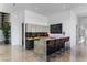 A modern bar area features sleek cabinetry, stone countertops, and comfortable seating at 631 Cityview Ridge Dr, Henderson, NV 89012