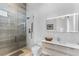 Bathroom showcases a textured wall, a shower, toilet, and vanity with a modern lighted mirror at 631 Cityview Ridge Dr, Henderson, NV 89012