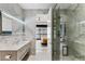 This modern primary bathroom offers a vanity, large mirror, glass shower, and high-end finishes at 631 Cityview Ridge Dr, Henderson, NV 89012