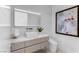 Stylish powder room with floating vanity, square vessel sink, unique textured wall, and modern art at 631 Cityview Ridge Dr, Henderson, NV 89012