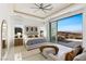 Bedroom features a ceiling fan and sliding glass doors that opens to a balcony with city and mountain views at 631 Cityview Ridge Dr, Henderson, NV 89012