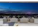 Sweeping views of the Las Vegas skyline from the patio with comfortable outdoor seating at 631 Cityview Ridge Dr, Henderson, NV 89012