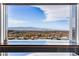 Stunning cityscape view framed by a modern kitchen interior, offering natural light and sleek design at 631 Cityview Ridge Dr, Henderson, NV 89012