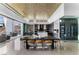 Open-concept dining area featuring a dining table, contemporary kitchen, and a stylish glass-enclosed wine cellar at 631 Cityview Ridge Dr, Henderson, NV 89012