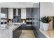 This contemporary kitchen features sleek cabinetry, a gray backsplash, and a spacious island with countertops at 631 Cityview Ridge Dr, Henderson, NV 89012