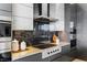 Sleek modern kitchen with gray and white cabinets, stainless steel appliances, and stylish backsplash at 631 Cityview Ridge Dr, Henderson, NV 89012