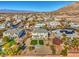 Aerial view showing a house's backyard, neighborhood, and mountain range at 6971 Cedar Basin Ave, Las Vegas, NV 89142