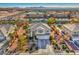 Aerial view of two-story house with a large backyard, driveway and mountain views at 6971 Cedar Basin Ave, Las Vegas, NV 89142