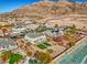 Aerial view of a house and neighborhood with a pool and mountain backdrop at 6971 Cedar Basin Ave, Las Vegas, NV 89142