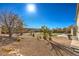 Landscaped backyard with gravel, grass, and a patio cover at 6971 Cedar Basin Ave, Las Vegas, NV 89142