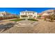 Large backyard with artificial turf, a concrete patio, and a two-story house at 6971 Cedar Basin Ave, Las Vegas, NV 89142