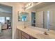 Clean bathroom with double vanity and a view into a bedroom at 6971 Cedar Basin Ave, Las Vegas, NV 89142