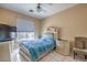 Bedroom with a queen bed, ceiling fan and tile flooring at 6971 Cedar Basin Ave, Las Vegas, NV 89142