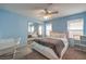 Light blue bedroom with a queen bed, ceiling fan and built in shelving at 6971 Cedar Basin Ave, Las Vegas, NV 89142