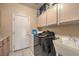 Laundry room with washer, dryer, cabinets, and a utility sink at 6971 Cedar Basin Ave, Las Vegas, NV 89142