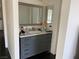 Bathroom with gray vanity, marble countertop, and large mirror at 705 Thousand Oaks Dr, Las Vegas, NV 89123