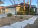 Single-story house with a two-car garage and landscaped front yard at 705 Thousand Oaks Dr, Las Vegas, NV 89123