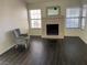 Living room featuring a fireplace and dark wood-look flooring at 705 Thousand Oaks Dr, Las Vegas, NV 89123