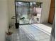 Bright living room featuring large sliding glass doors to the back patio and light, neutral tile floors at 705 Thousand Oaks Dr, Las Vegas, NV 89123