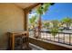 Relaxing balcony area with outdoor seating and a view of the lush landscaping and surrounding community at 7885 W Flamingo Rd # 1037, Las Vegas, NV 89147