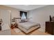 Spacious bedroom with a large bed, window with curtains and wood floors at 7885 W Flamingo Rd # 1037, Las Vegas, NV 89147