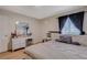 Spacious bedroom with a large bed, vanity, and wood floors at 7885 W Flamingo Rd # 1037, Las Vegas, NV 89147