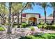 Exterior shot of the 'Rancho Viejo' clubhouse surrounded by meticulously maintained landscaping and mature trees at 7885 W Flamingo Rd # 1037, Las Vegas, NV 89147