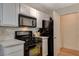 Modern kitchen with black appliances and white shaker cabinets at 7885 W Flamingo Rd # 1037, Las Vegas, NV 89147