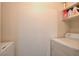 Laundry room with washer, dryer, and shelving at 7885 W Flamingo Rd # 1037, Las Vegas, NV 89147