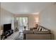 Living room with gray sectional sofa and a view of the balcony at 7885 W Flamingo Rd # 1037, Las Vegas, NV 89147