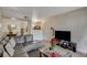 Open living area with gray sectional sofa and a view into the kitchen at 7885 W Flamingo Rd # 1037, Las Vegas, NV 89147